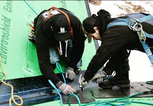 Two of the BC Roofing crew working on a slate roof.