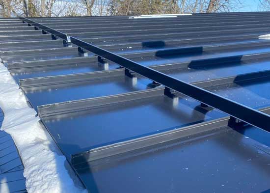 Black metal roof with a snow guard.